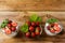 Layered strawberries diet yogurt dessert on wooden background