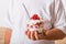 Layered trifle dessert with sponge cake, whipped cream and raspberries in child hands