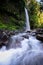 Layered water flows with cool air and green scenery are attractions that you can Sendeng Gile waterfall in Lombok, Indonesia.