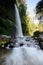 Layered water flows with cool air and green scenery are attractions that you Sendeng Gile waterfall in Lombok, Indonesia