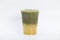 A layers of iced matcha green tea with concentrate yuzu flavor syrup mixed with sweet honey served in a clear 16oz. plastic glass