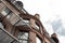 Layers of metal balconies on the brick exterior of a city apartment dwelling