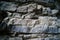 Layers of rock, dark natural stone. Mountain ridge. Wall. Geology. Natural texture, background