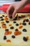 Laying dried fruit on sheet of yeast dough