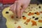 Laying dried fruit on sheet of yeast dough