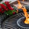 Laying flowers at the quenchless flame dedicated to victory World War II