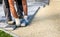 Laying gray concrete paving slabs in house courtyard driveway pa