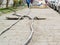 Laying of new cables in a manhole on the sidewalk. Opened hatch on the pavement while cables replacement. Underground construction