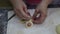 Laying and strengthening the sausage in the dough by hand on the kitchen table. Bakery products national traditional dishes