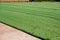 Laying synthetic artificial green grass on the future football field