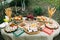 Laying of various cheeses on a large table in the open air