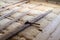 Laying wooden plank flooring on top of glass wool for warm insulation with carpenter hammer for home floor restoration