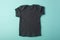 Layout Black children`s t-shirt on a turquoise background.Mockup .Flat lay