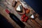 Layout of delicious gourmet snacks with bread and cheese and fruit on wooden planks with bottle of red wine.