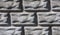 Layout of a gray concrete wall in the form of brickwork closeup porous texture