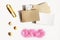 Layout of stationery items with space for text on a light background, paper clips, papers, pink sand and shells