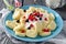 Lazy dumplings of cottage cheese with sour cream and berries