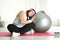 Lazy overweight woman leaning fit ball