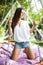 Lazy summer holidays. Young woman in hat relax in hammock in garden