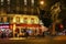 Le Dome night view, a traditonal French cafe located near the Eiffel tower in Paris, France.