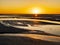 Le Mont Saint Michel, stunning sunset over the sand flats surrounding the famous abbey during low tide