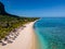 Le Morne beach Mauritius,Tropical beach with palm trees and white sand blue ocean and beach beds with umbrella,Sun
