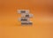 Lead and enable conversations symbol. Concept words Lead and enable conversations on wooden blocks. Beautiful orange background.