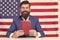 Lead with language. English language learner. Happy hipster hold book on american flag background. Language scholarships