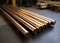 The leaded bronze round bars, rods are placed in an industrial setting with woodworking equipment visible in the