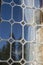 Leaded glass window reflects blue sky and trees