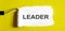 LEADER. One open can of paint with white brush on it on yellow background. Top view