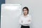 Leadership young Asian business woman standing in the office with white board in meeting room background.
