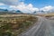 Leading lines and gravel road towards mountains