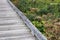 A leading view of a grey old boardwalk