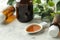 A leaf of ivy and syrup in a bottle on a light concrete table. Production of cough medicine with ivy extract. pharmaceutical indus