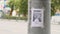 Leaflet about the missing child hanging on a pole,slow mo