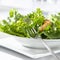 Leafy green salad with croutons and fork