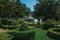 Leafy hedge and bushes in a wooden garden with fountain