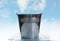 Leaky bucket with water against sky