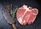 Lean matured raw t-bone steak and vintage cleaver