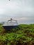 Leaning boat amidst the grass at coastal in Lecidere beach, Timor-Leste