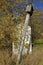 Leaning old birdhouse on pole