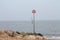 Leaning post marker at Mudeford, Dorset, UK