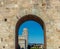 The leaning tower of pisa viewed through entrace arch of Piazza dei Miracoli