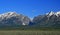 Lear Jet flying into Jackson Hole Airport next to the Grand Tetons Mountain Range in Wyoming