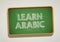 LEARN ARABIC written in chalkboard. Conceptual image with word LEARN ARABIC.