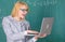 Learn it easy way. Online schooling concept. Woman teacher wear eyeglasses holds laptop surfing internet. Educator smart