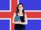 Learn Icelandic language concept. Portrait of happy pretty woman student against the Iceland flag background