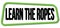 LEARN THE ROPES text on green-black trapeze stamp sign