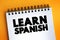 Learn Spanish text on notepad, concept background